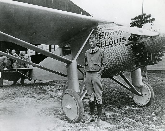 Lindbergh standing in front of the Spirit of St. Lewis