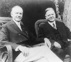 Former President Coolidge sitting next to gentleman