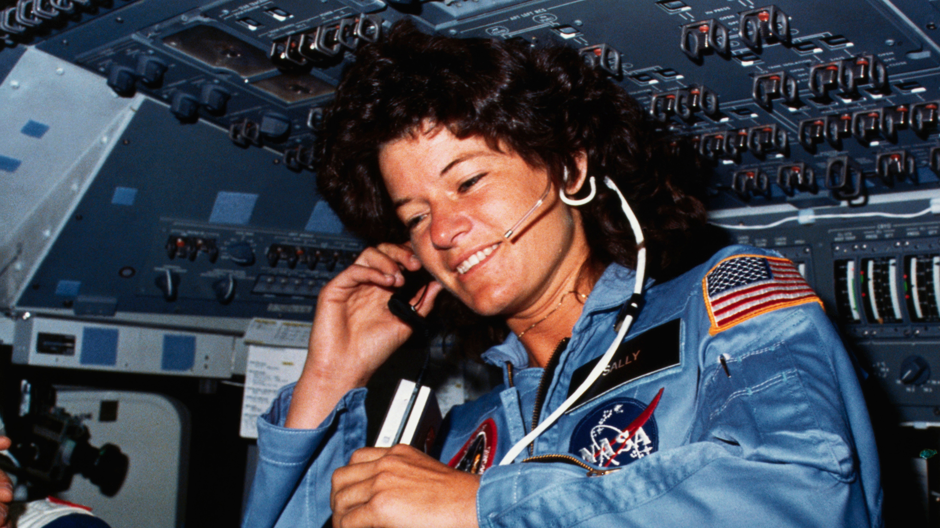 Sally Ride smiling inside spaceship
