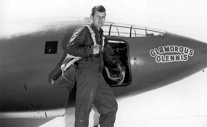 Chuck Yeager stands in front of plane with 'Glamorous Glennis' written on side